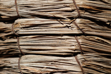 Tightly-bound bundles of dried straw close-up abstract textured background