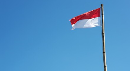 Indonesian Flag Waving Proudly Under a Clear Blue Sky
