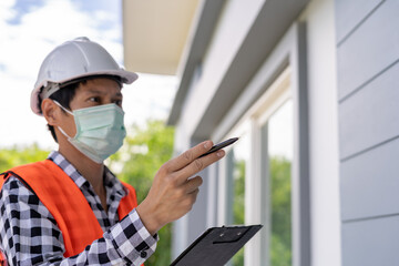inspector or engineer is inspecting construction and quality assurance new house. Engineers or...