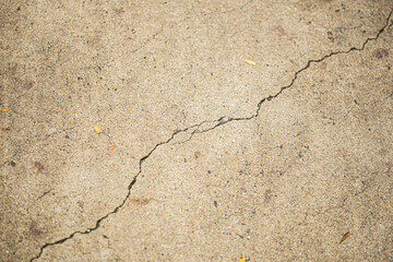Close up shot of concrete floor with oblique cracking, in light brown color, retro style