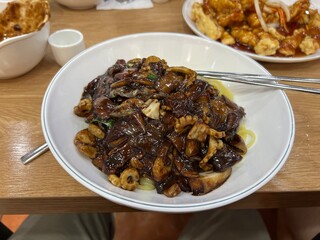 A bowl of Korean-style jajangmyeon with rich sauce and noodles perfectly combined.