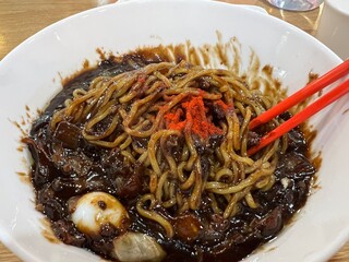A bowl of Korean-style jajangmyeon with rich sauce and noodles perfectly combined.