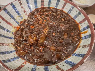 A bowl of Korean-style jajangmyeon with rich sauce and noodles perfectly combined.