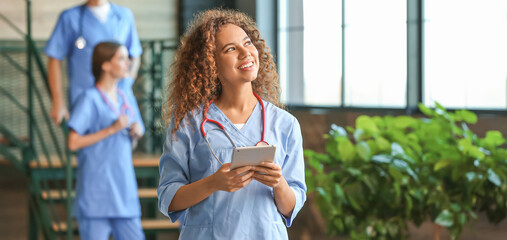 Female African-American medical student with tablet computer in clinic