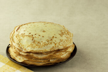 Many thin pancakes close-up. Stack of pancakes for breakfast.