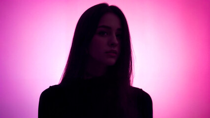 Side profile of a woman in neon light.