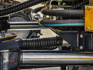 Close-up view of hydraulic system components in heavy machinery at a construction site during daytime