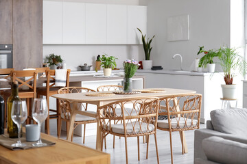 Interior of light open plan kitchen with dining table