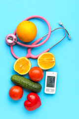 Glucometer with food, heart and stethoscope on blue background. Diabetes concept
