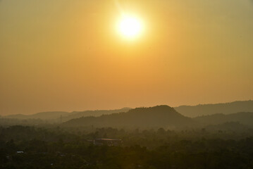 a sun over the mountains
