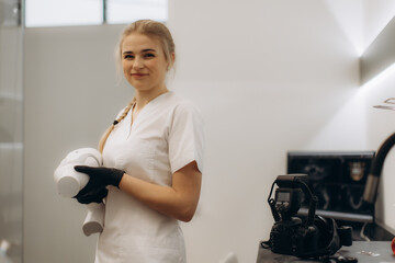 Professional Dental Assistant in Clinical Setting Holding Medical Equipment