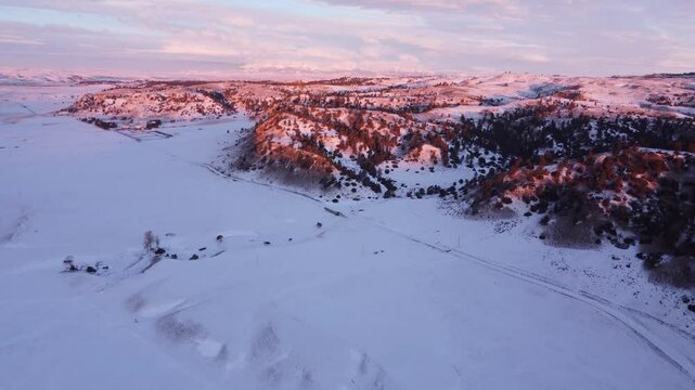 Montana hills in winter pink sunrise light 