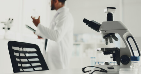 Microscope, man and scientist with tablet in lab for research, medical study and testing sample....