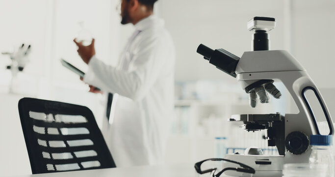 Microscope, man and scientist with tablet in lab for research, medical study and testing sample. Machine, person or biotechnology for experiment, dna production and confidence of vaccine breakthrough