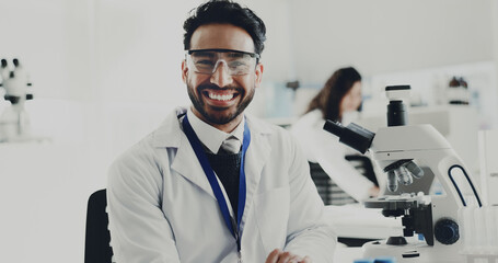 Portrait, man and scientist with microscope in lab for research, medical study and testing sample. Smile, male person and machine for experiment, dna production and confidence of vaccine breakthrough