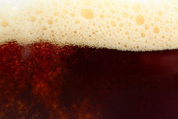 Dark beer with foam as background