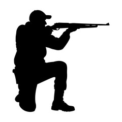 Silhouette of a hunter aiming a rifle while crouching