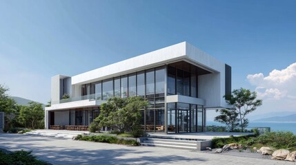 Modern two-story house with large glass windows and a minimalist design, set against a scenic backdrop.