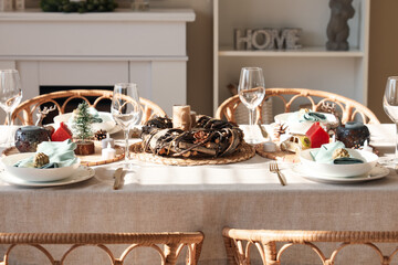 Beautiful table setting with Christmas decorations and candles in living room