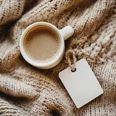 Overhead View of Coffee Cup on Beige Knit Sweater with Blank Tag