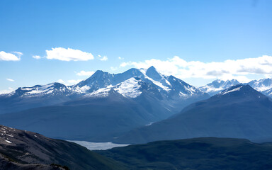 Majestic snowcapped mountains under a blue sky