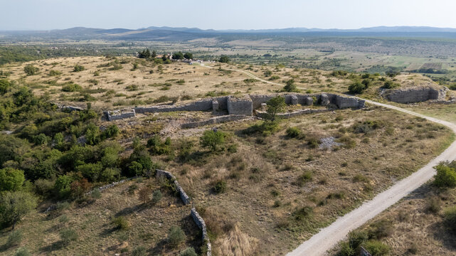 Aerial View of Ancient Ruins of Asseria, Croatia on a Grassy Hillside