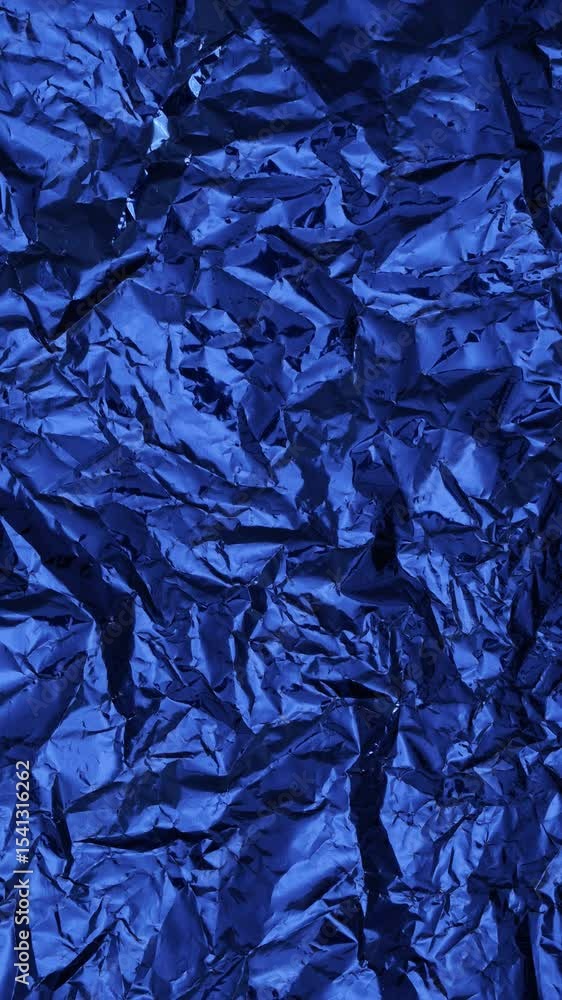 Poster artistic foil surface in dark blue with sharp wrinkles and subtle reflective shine. great for moody 