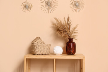 Different home decor on shelving unit near brown wall
