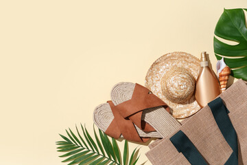 Composition with bag, beach accessories, wooden airplane and tropical leaves on beige background