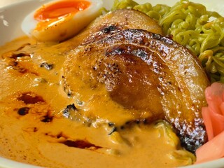 “Green Ramen Noodles in Creamy Pork Broth with Soft Egg and Pickled Ginger”