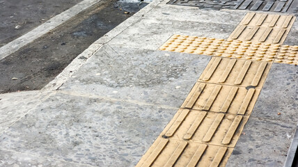 A sidewalk with tactile paving for visually impaired pedestrians