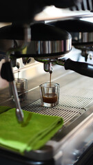 Professional Espresso Machine Pouring Fresh Coffee from Top Left Angle in Cafe Setting
