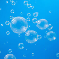 Obraz premium Clear bubbles floating in blue water, creating a refreshing underwater atmosphere