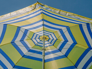Yellow-Blue Umbrella Against Blue Sky