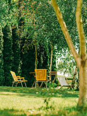 Yellow Folding Chairs in Summer Garden