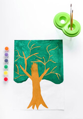Children's drawing: painted tree isolated on a white background. Children's creativity. Flat lay composition with child's painting. A sample for a child to draw a tree