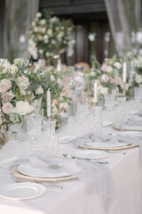 lovely Table setting for magnificent composition from flowers at a wedding , Centerpiece white and orange color palette flower bouquet arrangement
