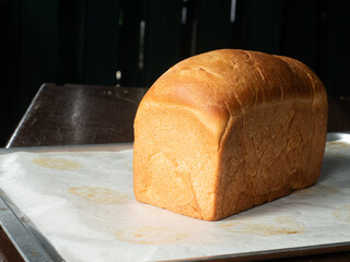 whole loaf of white bread on baking tray