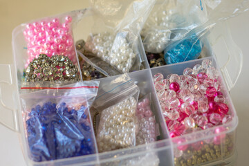 Colorful beads in plastic box for sale at a jewelry store.