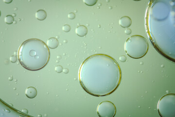 A macro image of oil bubbles diffused across a sponge-like green background. The organic shapes and smooth gradients create a soothing, abstract visual perfect for skincare, science, or design themes.