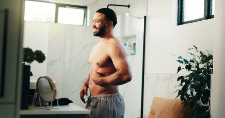 Happy man, belly and weightloss in bathroom for personal care or self confidence at home. Male...