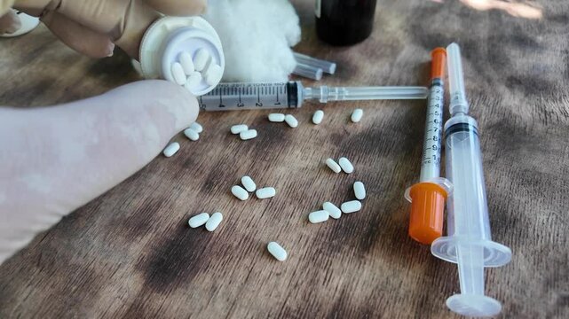 Videos on the topic of health care and medicine. Syringes and needles. Pills and syringes. Medical procedures. Injections. Taking medications. Treating patients.