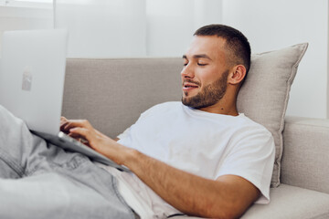 Relaxed man enjoying a digital detox on his laptop, embracing solitude while balancing personal and...