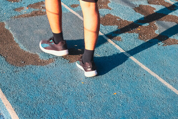 Cropped of people legs walking on athlete track or running track in morning time