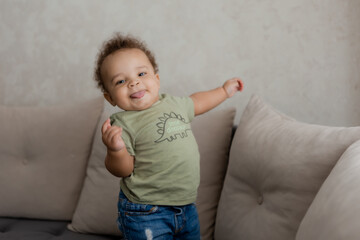 Fototapeta premium portrait of an African-American baby smiling at home