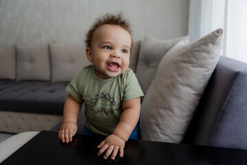 portrait of an African-American baby smiling at home