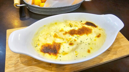 Gratin Delight: A close-up of a delectable gratin dish, the golden-brown crust beckons with its tempting texture and aroma. Baked to perfection, this culinary creation is a feast for the senses.