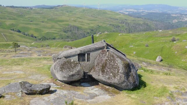 Aerial view of Casa do Penedo, build between boulders in the portuguese mountains.