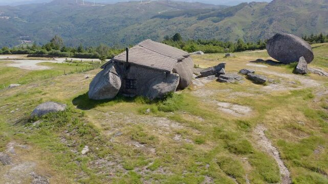 Side view of Casa do Penedo in the Portuguese mountains. Drone shot.