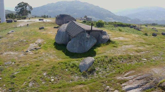 Casa do Penedo, rock house in the Portuguese mountains seen from the air.